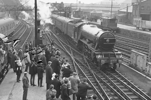 Trainspotters taking photographs of the Flying Scotsman steam engine at Waverley Station in April 1966.