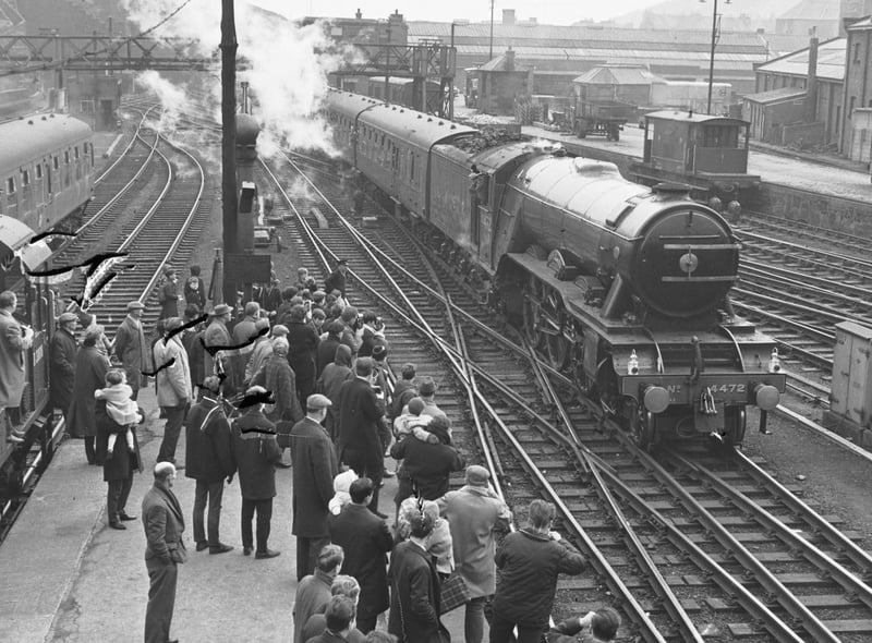 Trainspotters taking photographs of the Flying Scotsman steam engine at Waverley Station in April 1966.