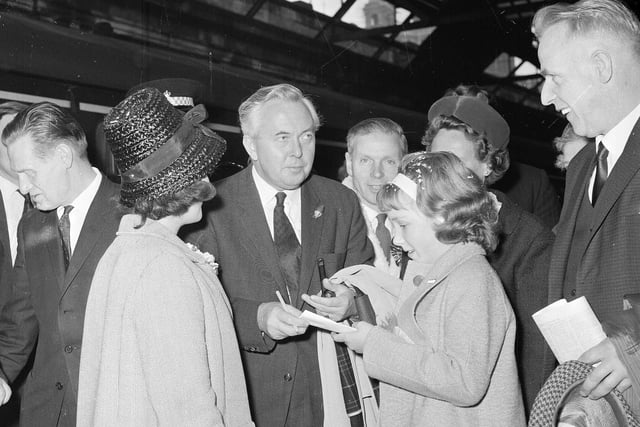 Harold Wilson at Waverley Station signing an autograph book in October 1964.