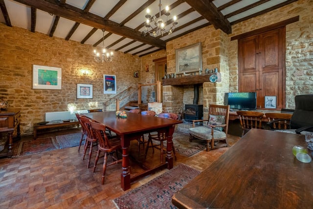 The house has a spacious dining room with exposed stone walls, parquet flooring and wood burning stove.