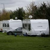 Police speak to travellers who have parked their caravans on a field in Banbury