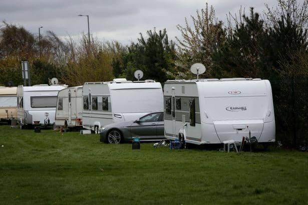 Police speak to travellers who have parked their caravans on a field in Banbury