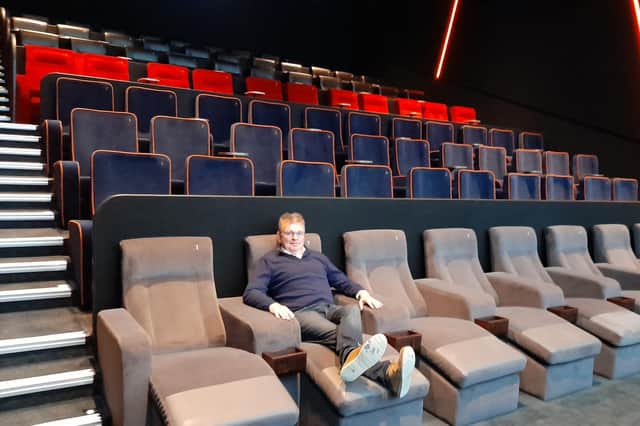 James Morris, CEO of The Light cinema, sits in one of the recliner seats inside one of seven cinema screens set to open on Friday May 27