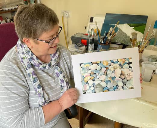 Deborah Weaver with one of her paintings - Beach Pebbles