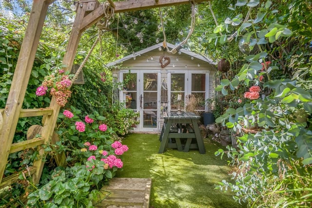 The garden has a insulated summer house or office with power.