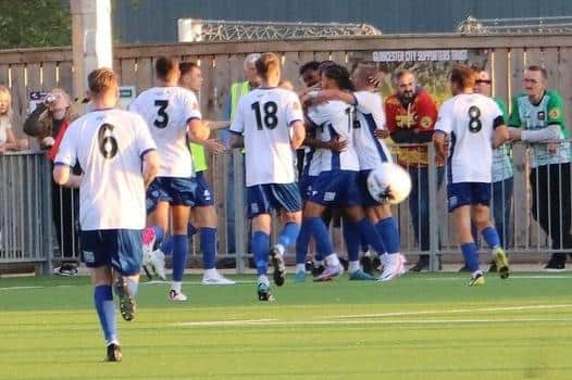The Banbury United players celebrate Ken Charles' first goal in their 2-0 success at Gloucester City on Tuesday night. Picture courtesy of Banbury United FC