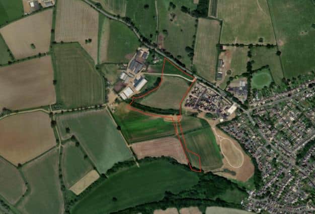 An aerial view of the west side of Bloxham showing the proposed housing site, ringed in red