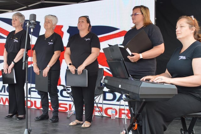 The Brize Norton Military Wives Choir sang traditional and modern songs live on stage.