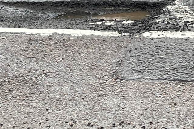 The deep pothole on the road at the edge of Clifton