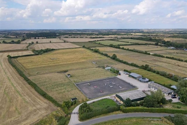 A picture taken by a drone of the yard and surrounding countryside.