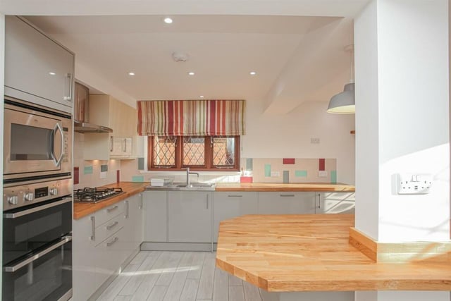 The kitchen features a modern oven and hob as well as a large island.