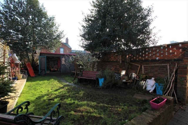 The sizable rear garden contains a block paving patio area with the rest of the garden mostly lawn, and is enclosed by a timber panel fence and brick wall.