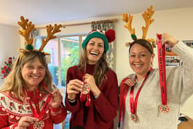 Rachel Burns, Roseann Thompson and Sue Blank from Katharine House Hospice show off this year’s greener wooden Santa Fun Run medals.