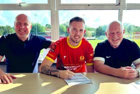 Tai Fleming signs on the dotted line alongside Banbury United manager Mark Jones and chairman Ronnie Johnson. Pictures courtesy of Banbury United FC
