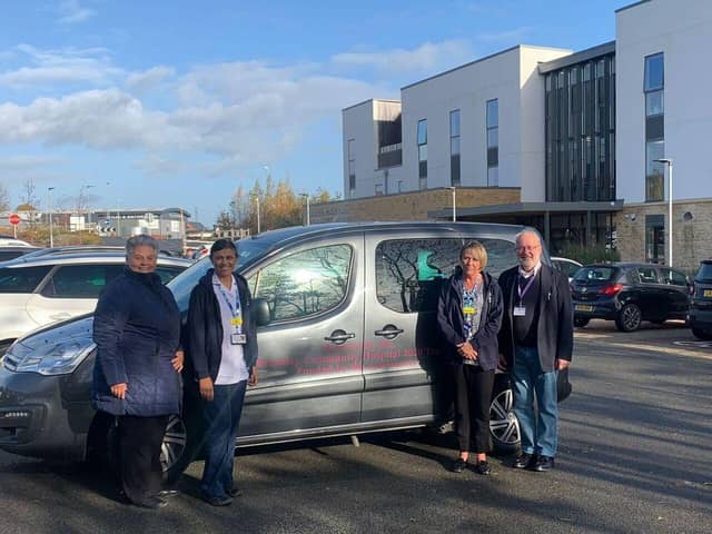 Caryl Billingham, left, is pictured with and hospital staff and trustees outside Brackley Community Hospital with the new patient transport car