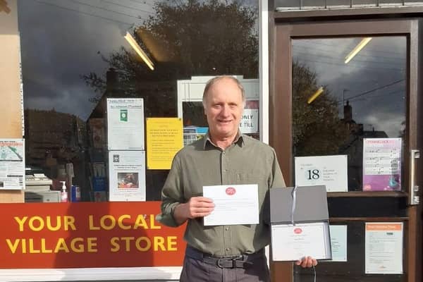 Nigel Barrett of Barretts stores and Post Office in Greatworth has been presented an award for 30 years of service to the community.