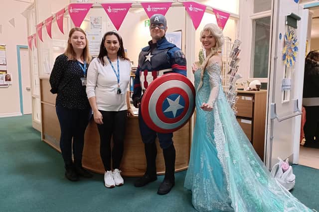 Centre staff members Emma Andrews and Kelly Dela Pena with Captain America and Cinderella.