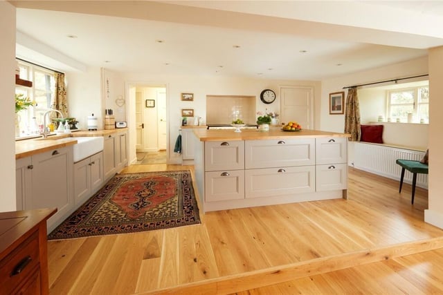 The kitchen features a large island, a built in dishwasher and a generous pantry.
