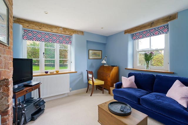 The small sitting room has a log burner, and is an ideal work from home area.