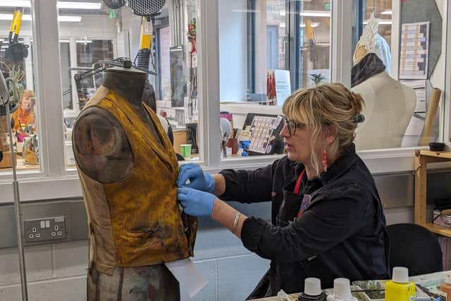 Jenny Cowgill of Leamington ensures the waistcoat of Old Joe looks suitably worn and dirty