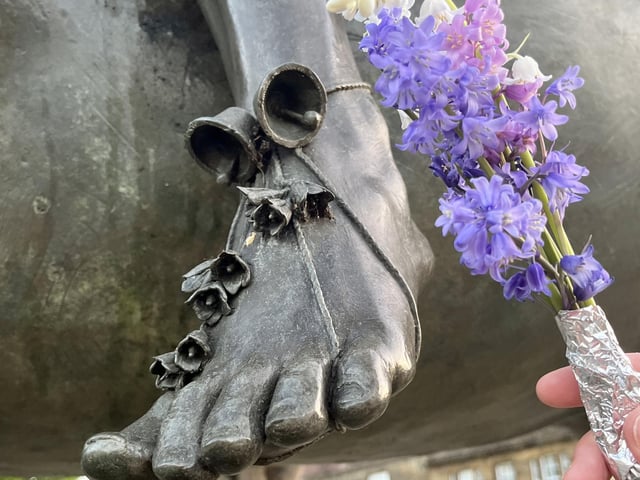 Members of the public laid flowers at the feet of the Fine Lady.