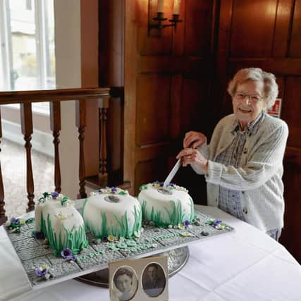 Joyce Brown is pictured with her 100th birthday cake at her surprise party at the Whately Hall Hotel, Banbury