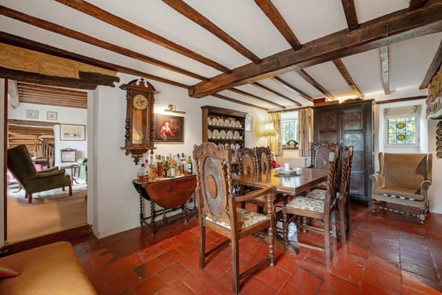 The dining room has a large inglenook fireplace, tiled flooring and space for a table to seat eight guests.