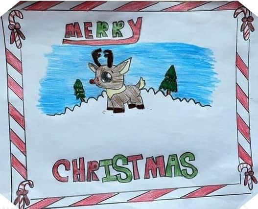 A card designed by Lulu, aged eight, who will not see one of her parents this Christmas
