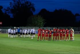 The Brackley and Hereford players paid their respects to Queen Elizabeth II ahead of kick-off at St James Park on Tuesday