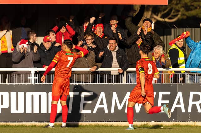 Henry Landers celebrates in front of the Banbury United fans after scoring the equaliser in the 1-1 draw at local rivals Brackley Town on Boxing Day. Picture by Glenn Alcock