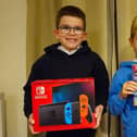 Brothers William and Henry Hardwell with their Nintendo Switch and new game.