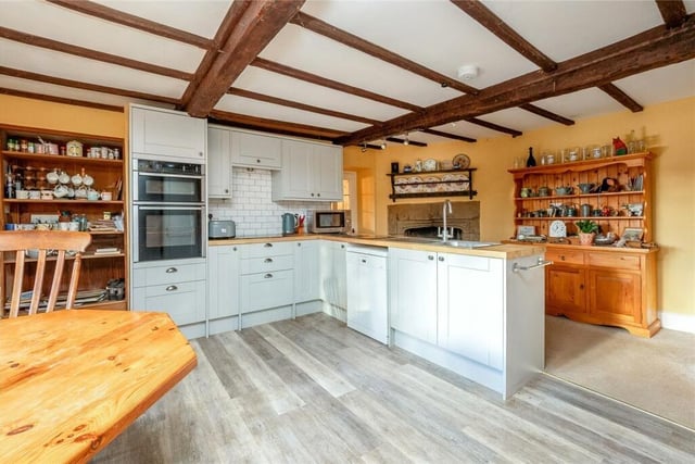 The kitchen and breakfast room also contains a fireplace as well as a Mullion stone window and window seat.