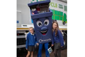 Ava Smith and Mollie Malcher with Binbo the council's recycling mascot.