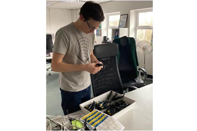 A staff member from Banbury-based mobile phone accessories manufacturer juice® works with some of the charging devices shipped to Ukraine to help families remain connected during the ongoing conflict. (photo from juice)