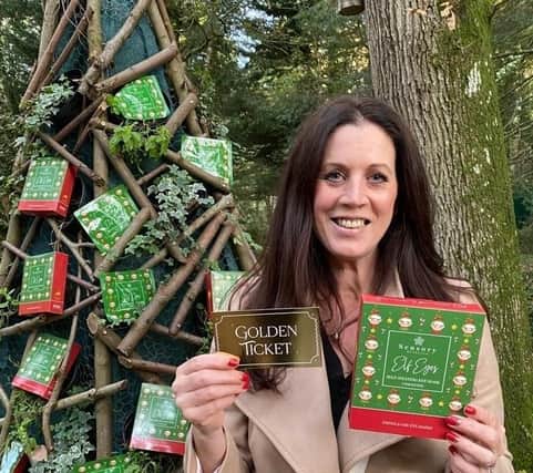 Claire Anderson with the golden ticket that is the key to the prize trip to Lapland