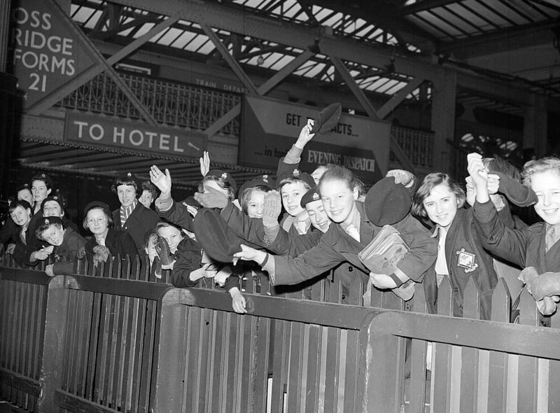 Guides wave at Lady Baden Powell on her arrival at Edinburgh Waverley Station in March 1959.