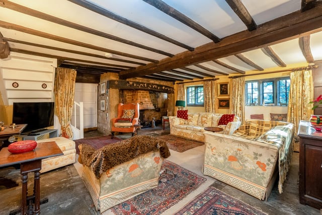 The sitting room has a large fireplace and exposed ceiling beams giving it plenty of character.