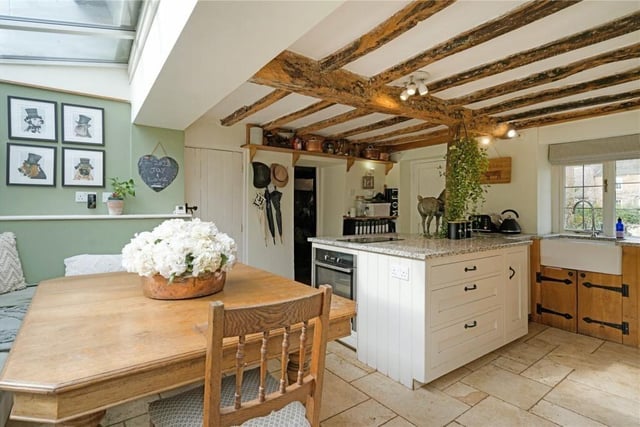 The open plan kitchen area offers a Belfast sink, an Aga situated within an inglenook fireplace and granite worksurfaces.