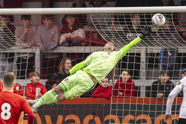 Danny Lewis makes a flying save during Brackley's victory over Darlington
