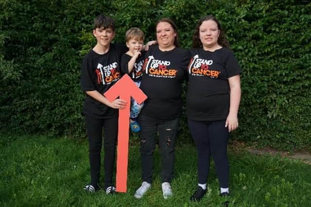 Clare Kirby and children (L-R) Oscar, Ezra and Skye support a new Stand Up To Cancer funded trial for the rare form of lymphoma that her husband Martin died of.
