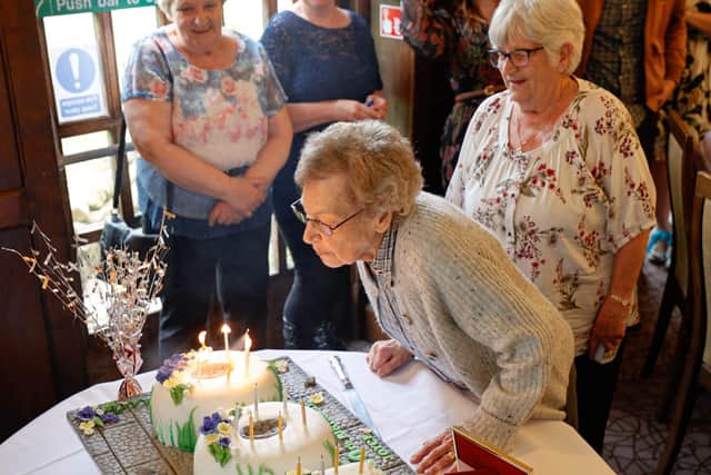 Joyce Brown blows out the candles on her special 100th birthday cake