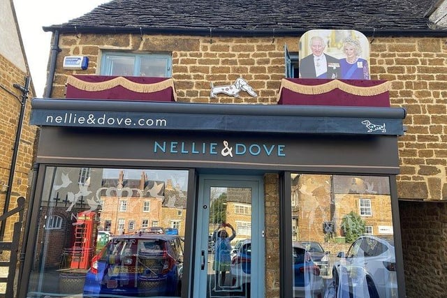 Nellie & Dove has decorated its Deddington Boutique, ready for the grand Coronation of the King this weekend. 
The business has put on displays for other events - and this year, staff have created a palace balcony, clad in red velvet with golden fringing, with a royal cardboard cutout!