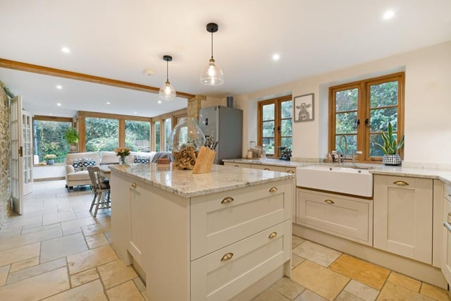 The kitchen has been modernised with base and wall units, marble worktops, a double deep glazed sink, and modern double Aga.