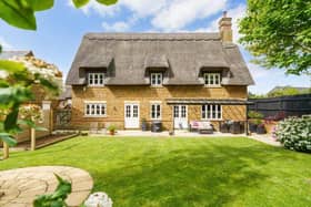 The impressive home has a Norfolk Reed thatched roof.