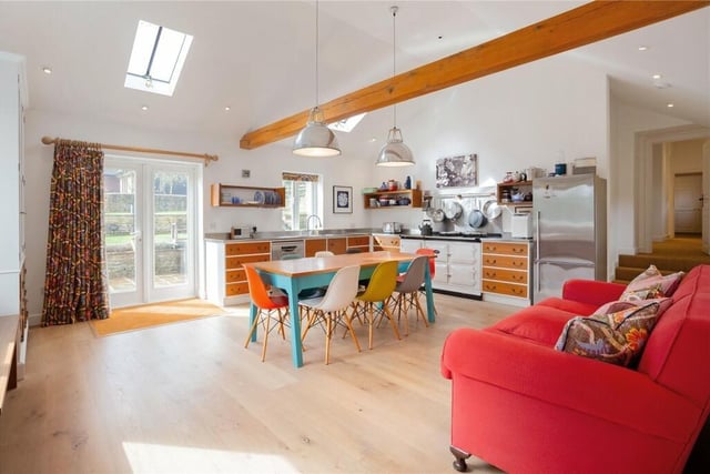 The house has a modern kitchen with an Aga cooker and doors leading to the garden.