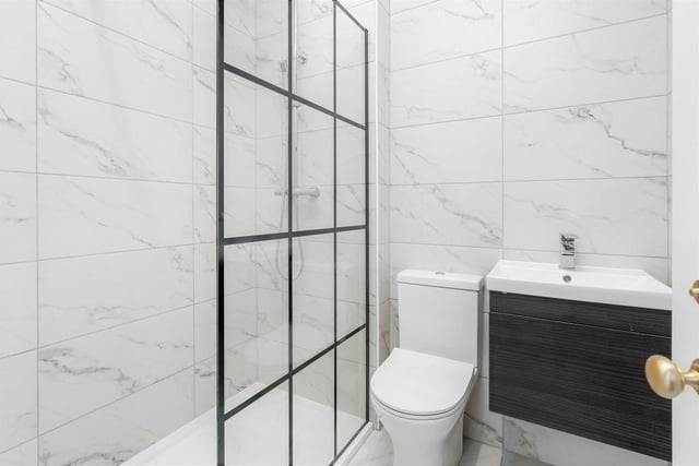 The porcelain tiled floor and walls bathroom comes with a rainfall shower and a heated towel rail.