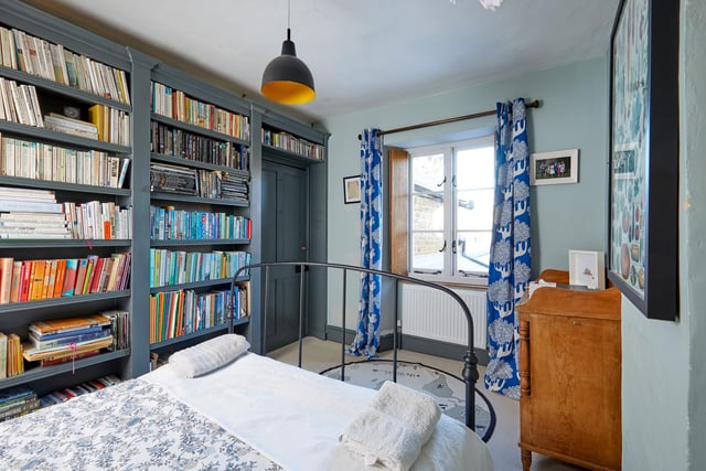 One of the property's bedrooms contains a bespoke integrated bookcase.