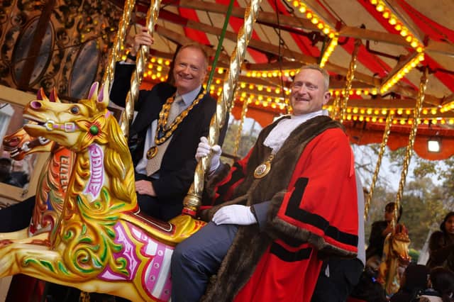Banbury Town Mayor Mark Cherry and Cherwell District Council chair Cllr Nigel Simpson enjoy a ride on the carousel.