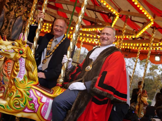 Banbury Town Mayor Mark Cherry and Cherwell District Council chair Cllr Nigel Simpson enjoy a ride on the carousel.