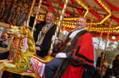 Banbury Town Mayor Mark Cherry and Cherwell District Council chair Cllr Nigel Simpson enjoy a ride on the carousel.